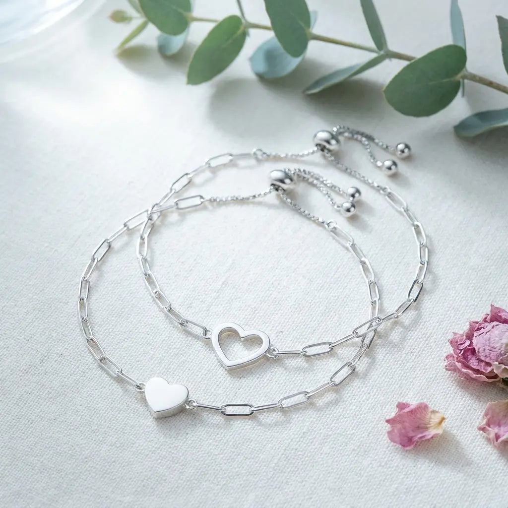 Polished smooth heart pendants — soft sparkle.