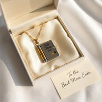 Best Mom Ever book locket necklace in cream gift 
box with To the Best Mom Ever card on silk — 
gift-ready Mother's Day present