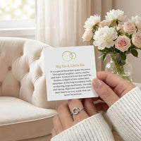 Woman reading Big Sis Little Sis sister message card 
wearing silver interlocking circles ring lifestyle