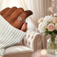 Woman wearing silver Big Sis Little Sis interlocking 
circles ring on finger lifestyle peonies cream