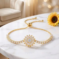 Gold crystal sunflower bracelet full design top-down on 
white marble marquise petals tennis chain detail