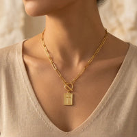 Carried By Faith gold cross necklace worn on collarbone