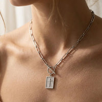 Carried By Faith silver cross necklace worn on collarbone
