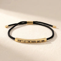 Don't Let The Hard Days Win bracelet available 
in three variants — black with gold plate, 
pink with silver plate, pink with gold plate 
— motivational bracelet color options