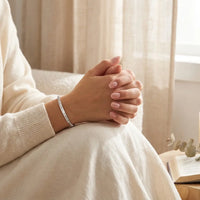 Woman's hands clasped in prayer wearing God Is 
Within Her bracelet — heartfelt Christian women 
empowerment faith jewelry