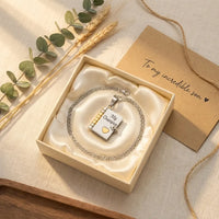 My Champion book locket necklace in cream gift 
box with To My Incredible Son card on silk — 
gift-ready keepsake for sons