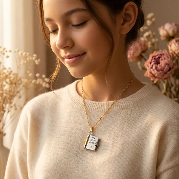 Young daughter wearing My Little Star book 
locket necklace at collarbone — silver and 
gold openable pendant, sentimental gift from 
mom to daughter