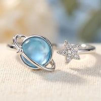 Macro detail of blue moonstone planet and pavé 
crystal star on Star and Moon daughter ring — 
premium celestial jewelry close-up