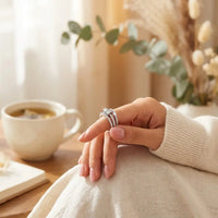 Young woman wearing To My Daughter fidget ring 
on finger using calming spinner gesture — 
mindfulness anxiety relief daily wear