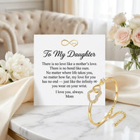 To My Daughter message card with gold infinity 
heart bangle bracelet on cream silk and marble — 
heartfelt mother daughter love note gift
