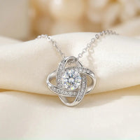 Silver love knot pendant macro detail with 6mm cubic 
zirconia center crystal pavé sparkle