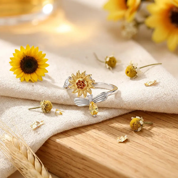 You Are My Sunshine ring in gold with spinning 
sunflower fidget design on cream linen — joyful 
anxiety relief gift jewelry